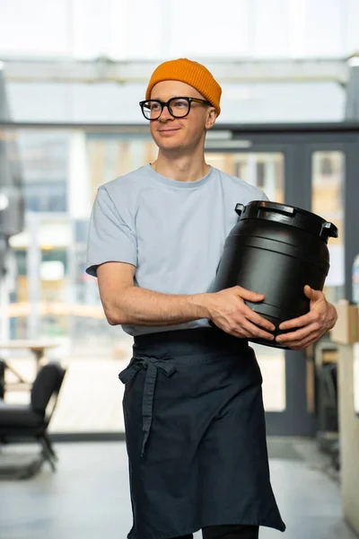 Positive Hipster Barista Wearing Hat Glasses Apron Carrying Barrel Preparing — Stock Photo, Image