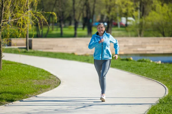 Parkta Koşmak Olgun Güzel Bir Kadın Parkta Koşuyor Mutlu Görünüyor — Stok fotoğraf