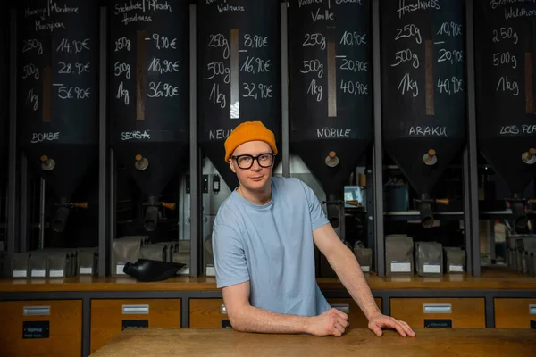 stock image Coffeemaker. Professional hipster barista in beanie hat and glasses standing at bar counter in coffee shop.