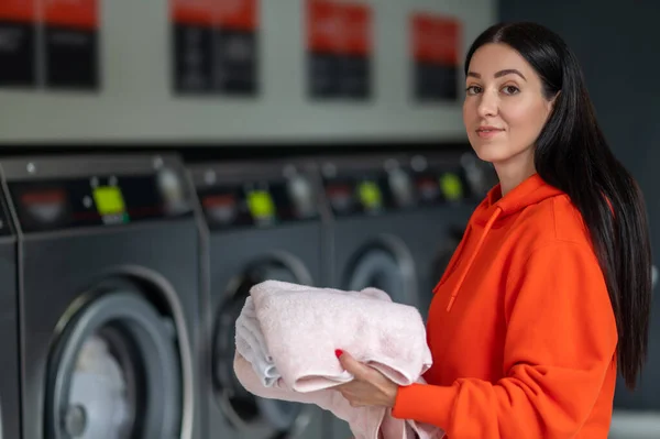 Laundry Service Brunette Adult Woman Wearing Orange Hoodie Holding Washed — Stock Photo, Image
