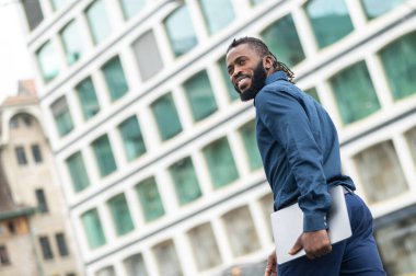 Confident man. Young dark-skinned tall man in denim clothes looking confident