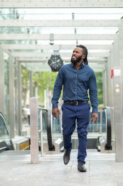 Confident man. Young dark-skinned tall man in denim clothes looking confident