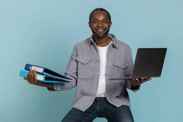 Neşeli Adam Mavi Arkaplandan Izole Edilmiş Dizüstü Bilgisayarında Çalışıyor — Stok fotoğraf