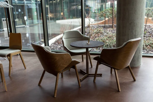 Modern interior. Picture of a round table and sevwral chairs around