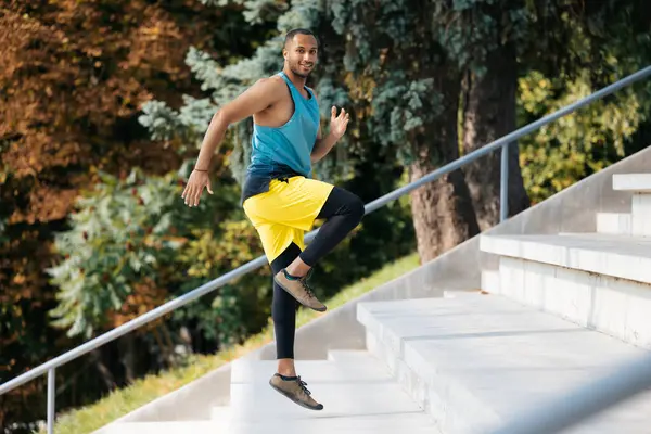 Workout. Dark-skinned sportsman running on the stairs during workout