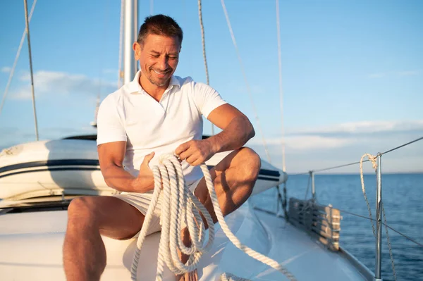 Yacht Man White Tshirt Sitting Yacht Rope Hands Stock Image