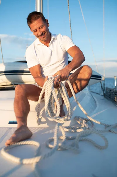Yacht Man White Tshirt Sitting Yacht Rope Hands Stock Image
