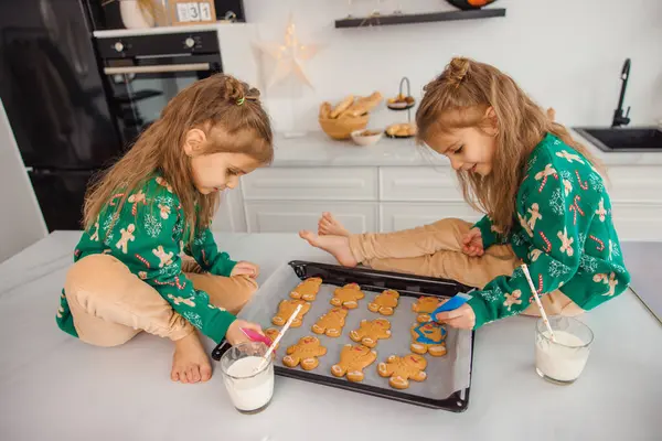 キッチンでクッキーを調理しながら忙しい2人の子供 — ストック写真
