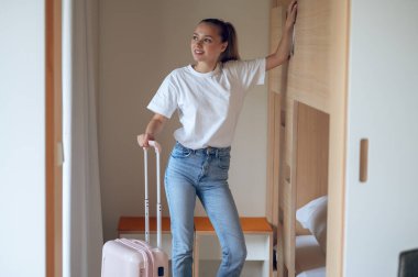 Gezgin. Bavullu hoş, modaya uygun bir genç kız.