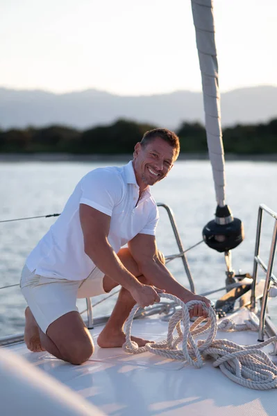 Sailing Smiling Man Yacht Fixing Rope Royalty Free Stock Photos