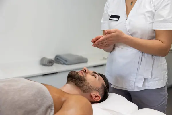 In a massage salon. Young man having relaxing procedures in a massage salon
