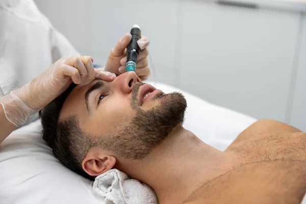 Beauty procedures. Man having cosmetological procedures in a beauty clinic