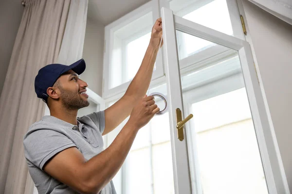Young Man Putting Sealing Foam Tape Window Indoors Insulating His — Stock Photo, Image