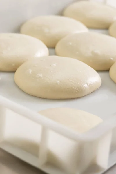 Close up of round dough pieces for pizza preparation