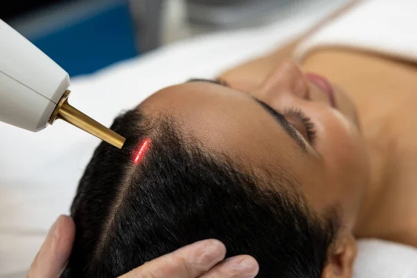 Laser procedures. Patient in a beauty clinic having laser procedures for hair