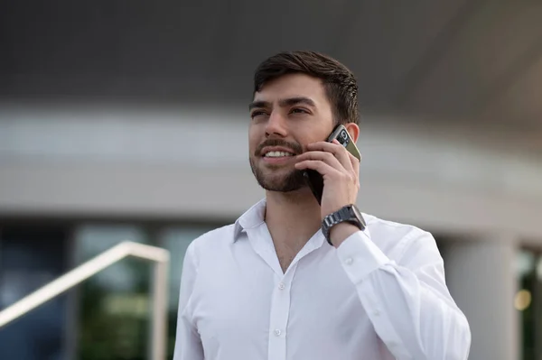 Phone call. Smiling young businessman talking on the phone
