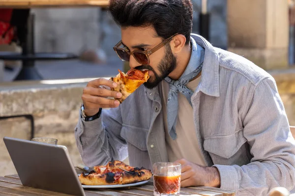 Pizza zamanı. Bir kafede pizza yiyen bir adam.