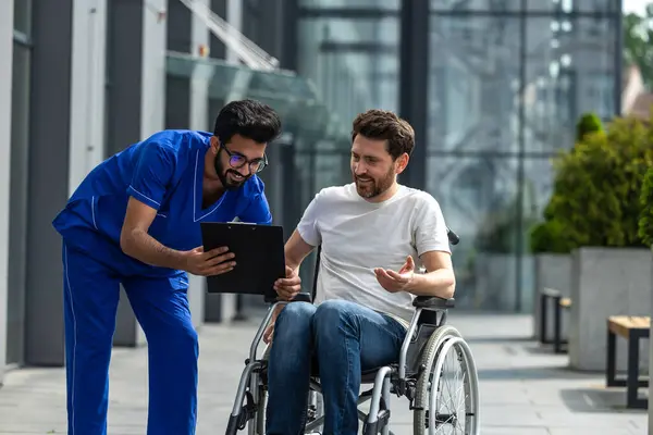 Prescription Man Sitting Wheelchair Discussing Something Male Nurse — Stock Photo, Image