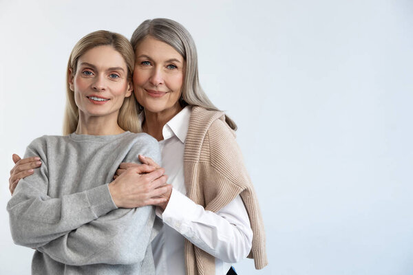 Family. Mother and daughter hugging each other and looking peaceful