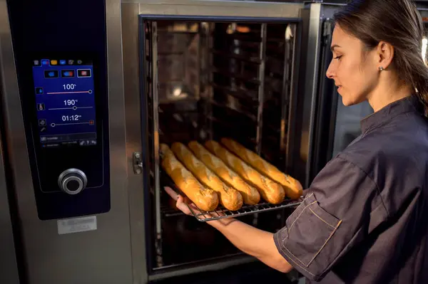 Woman Baker Using Electrical Oven Baking French Baguettes Bakehouse — Stock Photo, Image