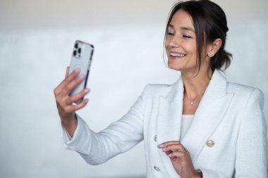 Business talk. Portrait of a business woman with a phone in hand clipart