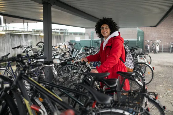 Renting Bike Smiling Curly Haired Guy Renting Bike Looking Contented Stock Photo