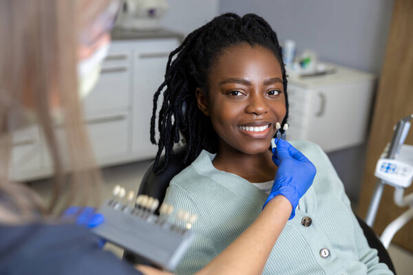 Contented woman. Smiling dark-skinned woman at the dentists looking contented
