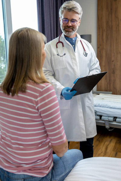 Doctors Office Blonde Female Patient Having Consultation Doctor Stock Photo