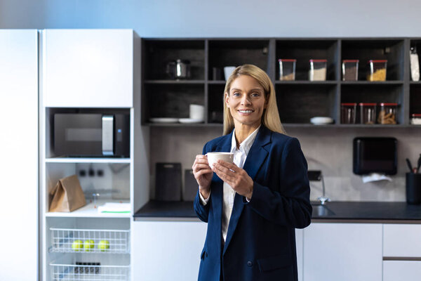 Smiling Caucasian Businesswoman Suit Standing Office Kitchen Drinking Coffee Stock Picture