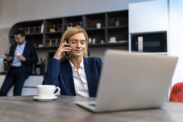 Beautiful Blonde Woman Professional Manager Using Laptop While Having Phone Stock Image
