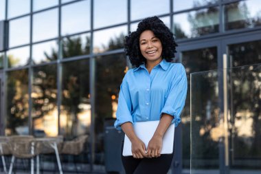İş kadını. İş merkezinin arka planında dizüstü bilgisayarı olan güzel esmer kadın.