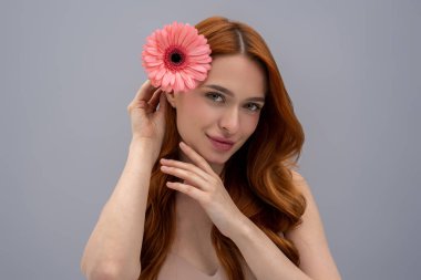 Cute woman. Portrait of a young cute woman in beige bra with a flower in hand clipart