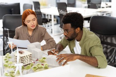 Meslektaşlar. Ofiste yeni sürdürülebilir bir proje üzerinde çalışan iki meslektaş