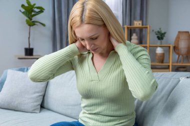 Baş ağrısı. Sarışın beyaz kadın kendini kötü hissediyor ve baş ağrısı çekiyor.