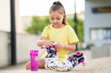 Genç bayan patenci dışarıda antrenman ve egzersiz için hazırlanıyor.