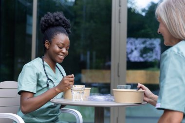 Öğle yemeği vakti. Doktor meslektaşlarım kafede birlikte yemek yiyorlar.