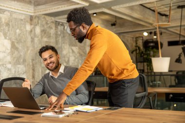 Ofiste yoğun bir gün. İş arkadaşları ofiste çalışıyor ve meşgul görünüyorlar.
