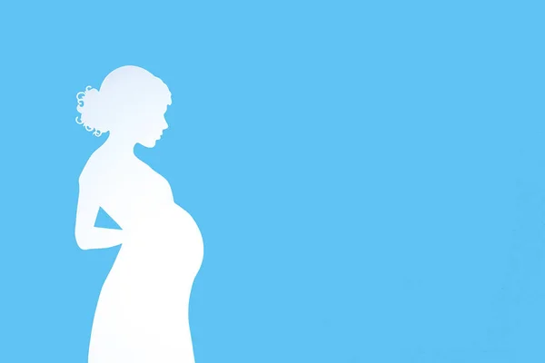 关于怀孕和母性的横幅 一个蓝色背景和文字空间的孕妇的轮廓 简约设计 — 图库照片