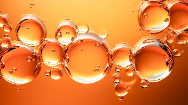 Kozmetik yağ damlaları ve altın bir arka planda hava kabarcıkları. Bir kozmetik ürünün dokusu.