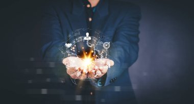 Businessman holding virtual world with icons and connection line for data exchange from globalization innovation technology and global business concept.