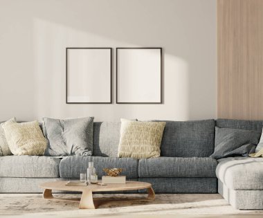 Lobide iki boş çerçeve, mavi kanepe ve duvarında ahşap pano olan bir masa.