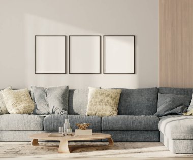 Lobide üç boş çerçeve, mavi kanepe ve duvarında ahşap pano olan bir masa.