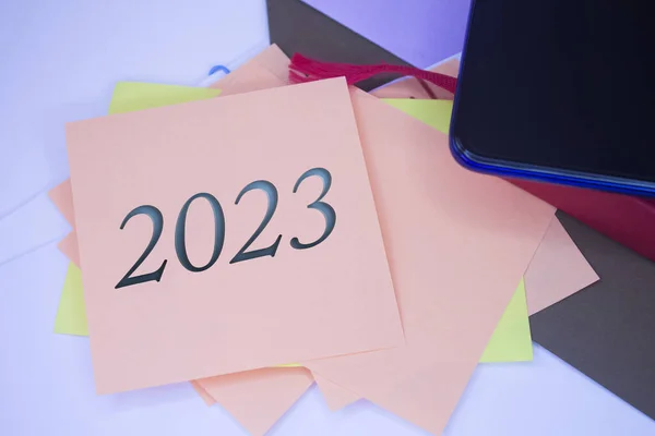 stock image The number 2023 on adhesive note paper. Event, celebration reminder message.