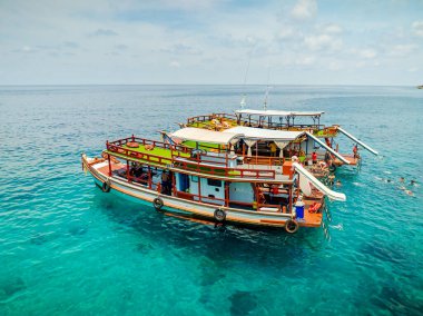 Doğal körfezin üst hava manzarası tonlarca gezgin turist alıyor. Tur tekneleri iniyor. İnsanlar yaz tatilinde birlikte su sporunun tadını çıkarıyorlar.