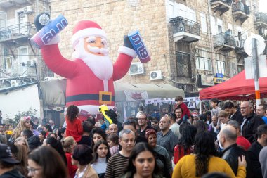 Hayfa, İsrail - 17 Aralık 2022: St. Elias Piskoposluk Okulu öğrencileri Alman Kolonisi 'ndeki Noel geçit törenine katıldılar. İzleyiciler geçidi izliyor