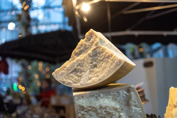 Quarter head of parmesan with cheese texture on the market for sale
