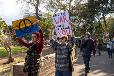 Haifa, Israel - February 24, 2023, the anniversary of the start of the war between Russia and Ukraine. Rally near the Russian consulate. Girl holding a poster - end the war before she ends you