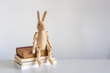 A white and black striped cup, a stack of books. Copy space