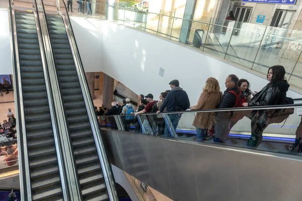 stock image JERUSALEM, ISRAEL - February 20 2023: Exterior glass lobby of the new underground railway station in Jerusalem People ride the escalator during rush hour.