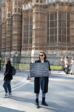 Londra, İngiltere -22.04.2023, Büyük Gösteri. Bir kadının elinde bir poster vardır. Kötülüğün zaferi için tek bir şey gereklidir. İyi bir adamın hiçbir şey yapmamasıdır.